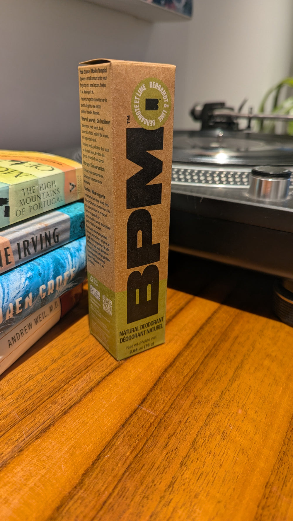 BPM packaging box on a wooden surface with turntable and books in the background